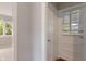 Hallway view to sunroom featuring white paint and trim, leading to different areas of the home at 4517 E 16Th St, Indianapolis, IN 46201