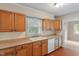 Cozy kitchen featuring wooden cabinetry, practical countertops, and a view to the backyard at 4517 E 16Th St, Indianapolis, IN 46201