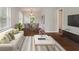 Stylishly staged living room with a dining area, creating a comfortable and functional living space at 4517 E 16Th St, Indianapolis, IN 46201