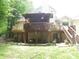 Multi-level deck with outdoor seating, surrounded by trees, and offering a peaceful backyard retreat at 4521 Tulip N Dr, Martinsville, IN 46151