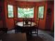 Dining area with large bay window, hardwood table, and four chairs at 4521 Tulip N Dr, Martinsville, IN 46151