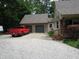 Charming home featuring a two-car garage, lovely landscaping, and a red truck in the driveway at 4521 Tulip N Dr, Martinsville, IN 46151
