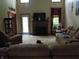 Cozy living room featuring plush sofas, a fireplace, and plenty of natural light with dog in the frame at 4521 Tulip N Dr, Martinsville, IN 46151