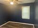 Bedroom showcasing laminate floors, ceiling fan and window at 4723 Crittenden Ave, Indianapolis, IN 46205
