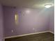 Bedroom showcases a purple painted wall and laminate flooring at 4723 Crittenden Ave, Indianapolis, IN 46205