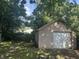 Exterior view of the detached garage featuring concrete block and white garage door at 4723 Crittenden Ave, Indianapolis, IN 46205