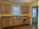 Functional kitchen with wooden cabinets, a window, and ample counter space at 4723 Crittenden Ave, Indianapolis, IN 46205