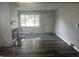 Spacious living room featuring hardwood floors, a fireplace, and a large window at 4723 Crittenden Ave, Indianapolis, IN 46205