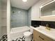 Modern bathroom with stylish tile, sleek vanity, and a shower-tub combination at 5115 Primrose Ave, Indianapolis, IN 46205