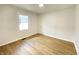 Bedroom with light wood vinyl flooring, white walls, and a window at 5115 Primrose Ave, Indianapolis, IN 46205