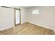 Bright bedroom with light wood vinyl floors, white walls, and a modern barn door at 5115 Primrose Ave, Indianapolis, IN 46205