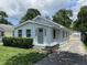 Charming home featuring light blue siding, tidy front yard, and a convenient private driveway at 5115 Primrose Ave, Indianapolis, IN 46205