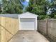 Garage with white garage door and newly constructed fence at 5115 Primrose Ave, Indianapolis, IN 46205