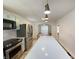 Well-equipped kitchen featuring stainless steel appliances, a center island, and modern lighting at 5115 Primrose Ave, Indianapolis, IN 46205