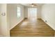 Inviting living room with wood-look floors and abundant natural light streaming through the window at 5115 Primrose Ave, Indianapolis, IN 46205