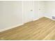Clean room featuring neutral walls, wood-look floors, and two doors at 5115 Primrose Ave, Indianapolis, IN 46205