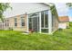 Green backyard with brick home and sunroom, perfect for outdoor enjoyment at 5217 Dunewood Way # 3002, Avon, IN 46123