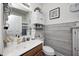 Cozy bathroom featuring a single sink vanity, white wooden walls, and modern fixtures at 5217 Dunewood Way # 3002, Avon, IN 46123