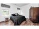 Calm bedroom featuring a black and white color scheme, wood floors, and two bright windows at 5217 Dunewood Way # 3002, Avon, IN 46123