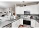 Bright kitchen features granite counters, modern appliances, and open view of living spaces at 5217 Dunewood Way # 3002, Avon, IN 46123