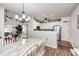 Open floor plan displaying a dining area connected to a kitchen with white cabinetry at 5217 Dunewood Way # 3002, Avon, IN 46123