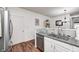 Galley kitchen featuring granite countertops, stainless steel appliances, and neutral backsplash at 5217 Dunewood Way # 3002, Avon, IN 46123