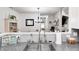 Close-up view of kitchen sink, granite countertops, and open view to dining area at 5217 Dunewood Way # 3002, Avon, IN 46123