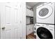 Functional laundry room with modern washer and dryer, white cabinets, and wood-look floor at 5217 Dunewood Way # 3002, Avon, IN 46123