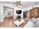 Open-concept living area with a fireplace, TV, and seamless flow to the dining space at 5217 Dunewood Way # 3002, Avon, IN 46123