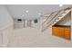 Large finished basement with recessed lighting and wooden stairs at 6030 Evanston Ave, Indianapolis, IN 46220
