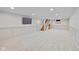 Spacious finished basement with recessed lighting, painted walls, and wooden stairs at 6030 Evanston Ave, Indianapolis, IN 46220