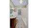 Charming bathroom with subway tile surround, wood vanity and patterned tile floor at 6030 Evanston Ave, Indianapolis, IN 46220