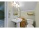 A full bathroom with a pedestal sink and stylish fixtures is bright and ready for its new owner at 6030 Evanston Ave, Indianapolis, IN 46220