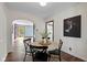 Bright dining area with wood floors and an arched doorway into another room, featuring a round table at 6030 Evanston Ave, Indianapolis, IN 46220