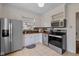 Updated kitchen with stainless steel appliances and light tile flooring at 6030 Evanston Ave, Indianapolis, IN 46220