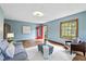 Cozy living room with hardwood floors, natural light, and a view of the front yard through the open door at 6030 Evanston Ave, Indianapolis, IN 46220