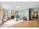 Bright living room featuring hardwood floors, stone fireplace, and comfortable seating area at 6030 Evanston Ave, Indianapolis, IN 46220