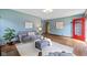 Open-concept living room with hardwood floors, ample seating, and stylish decor with natural light at 6030 Evanston Ave, Indianapolis, IN 46220