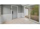 Sunroom features tiled floors, gray walls, and slider door overlooking the backyard at 6030 Evanston Ave, Indianapolis, IN 46220