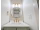 Stylish bathroom with a round mirror, modern lighting, and gold fixtures at 608 Manhattan Ave, Indianapolis, IN 46241
