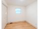 A bright, empty bedroom with wood-look flooring and a closet at 608 Manhattan Ave, Indianapolis, IN 46241