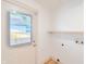 Bright laundry area featuring a utility sink, windowed exterior door, and washer/dryer hookups at 608 Manhattan Ave, Indianapolis, IN 46241