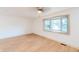 Spacious living room with light hardwood floors and a large bay window, letting in ample sunlight at 608 Manhattan Ave, Indianapolis, IN 46241