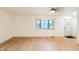 Bright living room featuring a bay window, wood floors, and a glimpse of the front entrance at 608 Manhattan Ave, Indianapolis, IN 46241