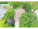 Aerial view of the home's roof, driveway, and surrounding lush green landscaping and mature trees at 610 Front Royal Dr, Indianapolis, IN 46227