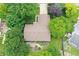 Aerial view of the home's roof, backyard deck, and surrounding lush green landscaping and mature trees at 610 Front Royal Dr, Indianapolis, IN 46227