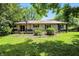 Home featuring a well-maintained lawn, deck and bench swing for outdoor relaxation at 610 Front Royal Dr, Indianapolis, IN 46227