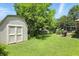 Spacious backyard featuring a shed, well-kept lawn, and a cozy swing bench at 610 Front Royal Dr, Indianapolis, IN 46227