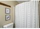 Charming bathroom features a patterned shower curtain and framed artwork at 610 Front Royal Dr, Indianapolis, IN 46227