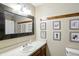 Bathroom features a modern vanity with a decorative mirror and artwork at 610 Front Royal Dr, Indianapolis, IN 46227